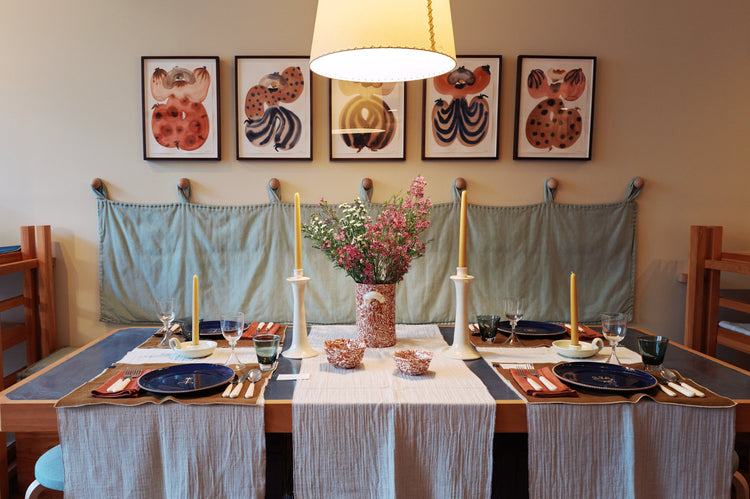 table with plates and art hanging