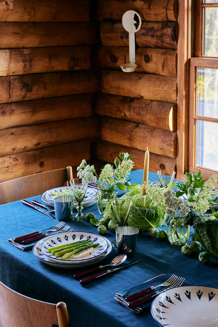 table with plates and vegetable centerpiece