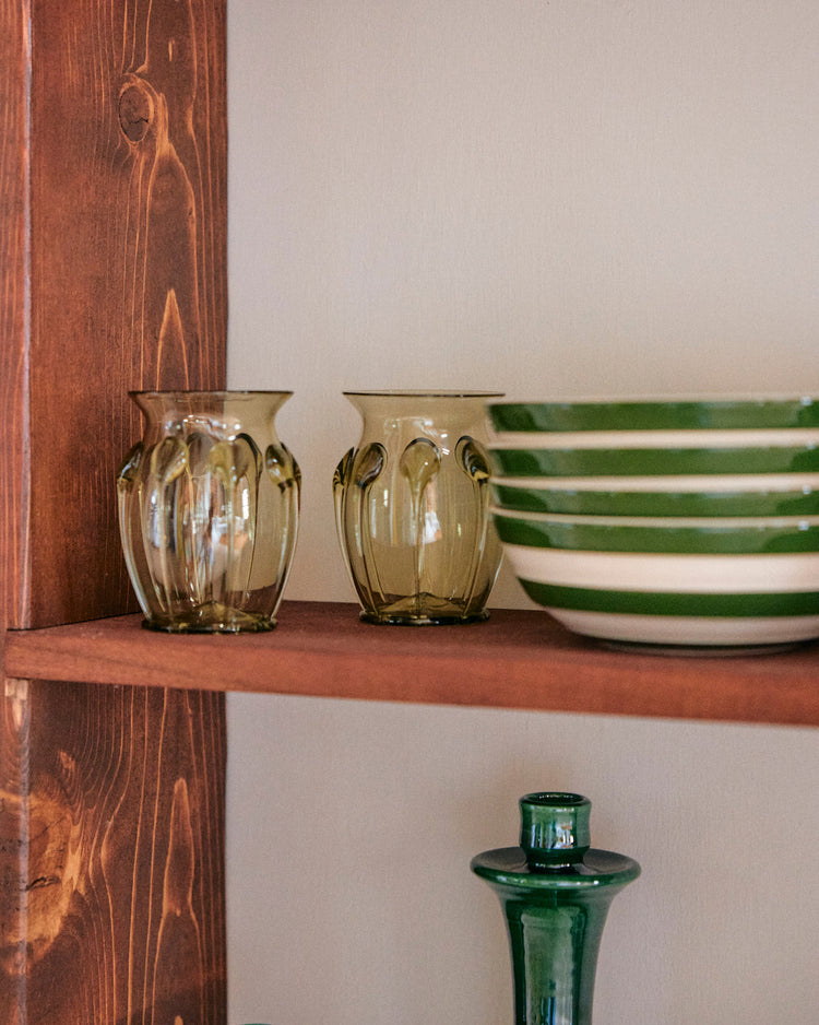 wood shelf with glass vase and green bowls