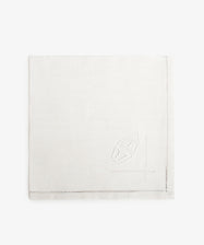 Vintage French Monogrammed Napkin. White damask napkin with embroidered design motif.