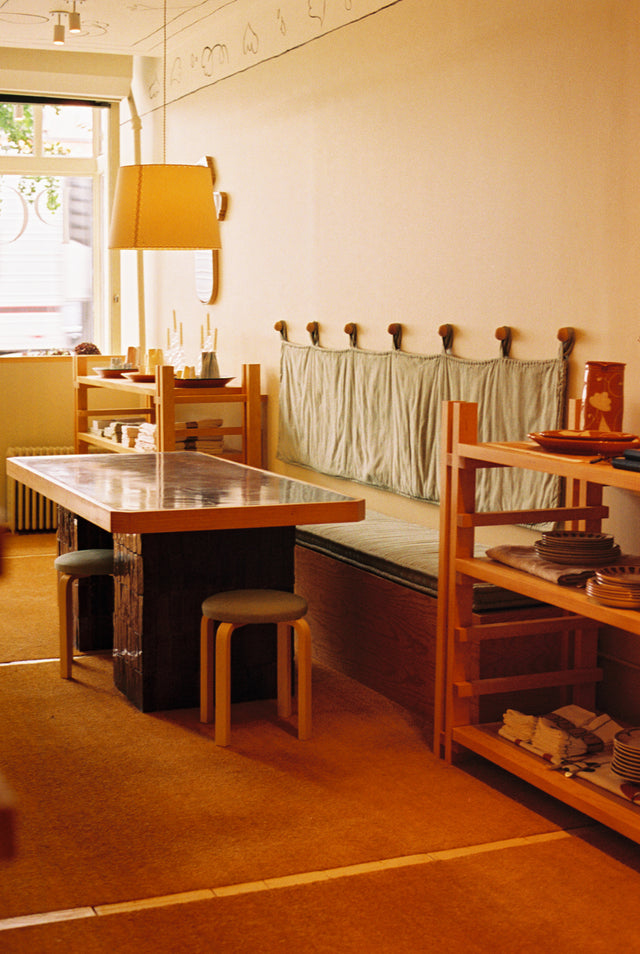interior of store with table and bend with wood shelves