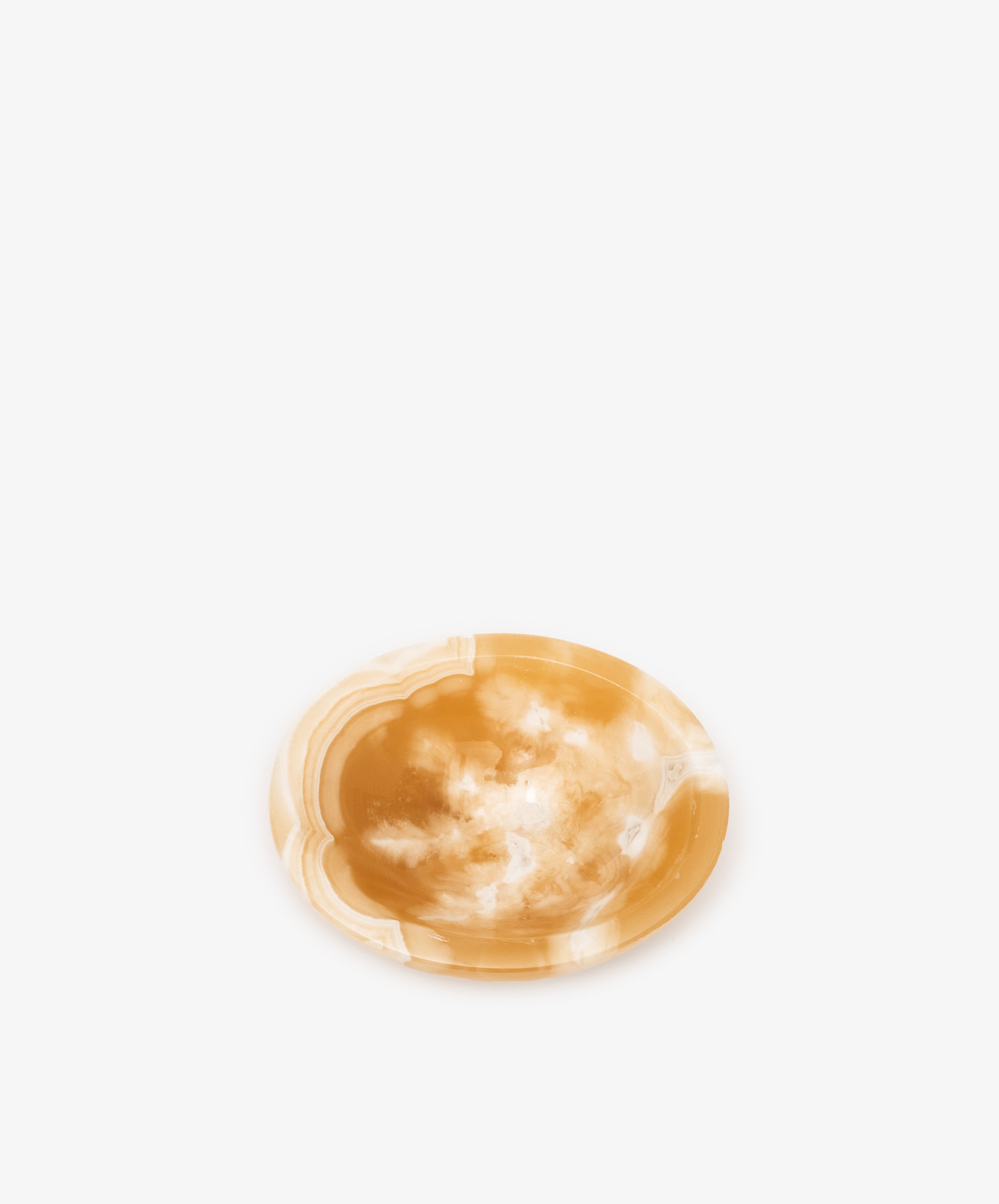 An alabaster catchall bowl of white and deep yellow coloring, ideal for organizing small objects.