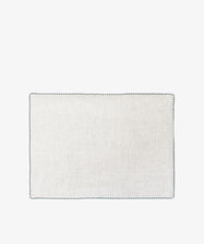The Nico Placemat, Set of 6, features white squares with black borders and hand-stitched edges—ideal for elegant table decor or refined linen placemats.