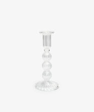 The Elsa Candleholder is a clear, hand-blown glass piece with a ribbed surface and round, tiered stem, expertly crafted by artisans and displayed against a plain white background.
