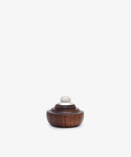 The Curiosity Box 16 is a small, round African wood box with a dark finish, featuring a tiered lid and silver knob, pictured on a plain white background.