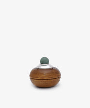 Curiosity Box 6: A small, round African wood box featuring a metallic lid with a green spherical knob on top, displayed against a plain white background.