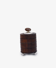 Curiosity Box 8: A small, cylindrical African wood box with a domed lid, metal accents, and three round metal feet, displayed on a plain white background.