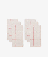A collection of six napkins featuring a red and natural check pattern.