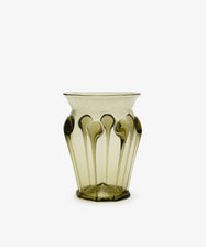The Carlotta Vase is a mouth-blown, translucent olive-green vase featuring a flared rim and vertical teardrop accents, highlighting Bohemian artistry against a plain white background.