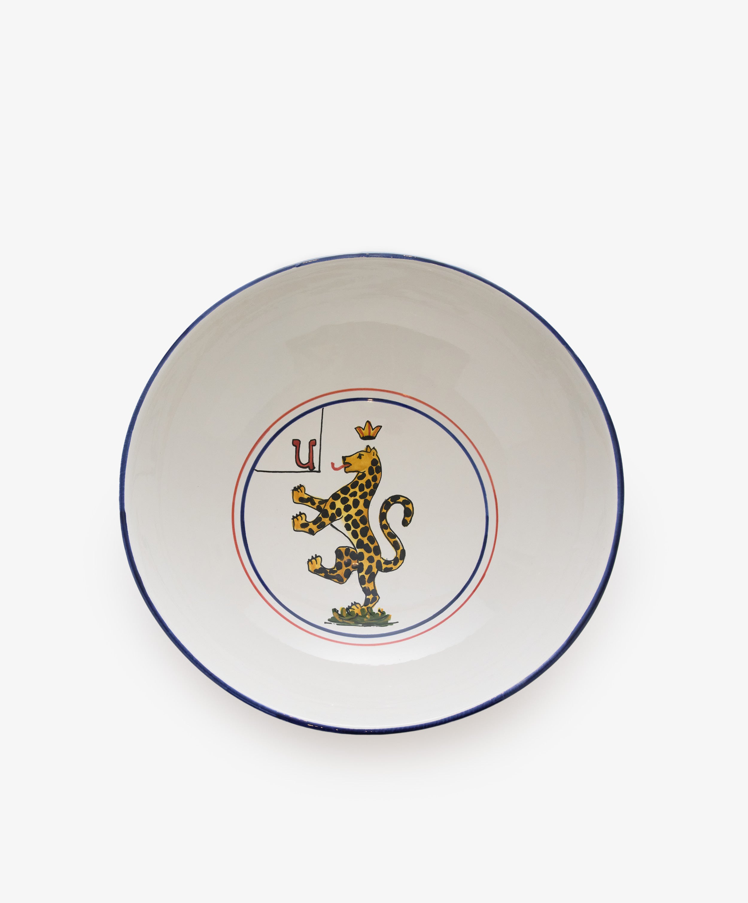 Palio Serving Bowl. Large white glazed ceramic bowl with red and blue accents and panther motif.