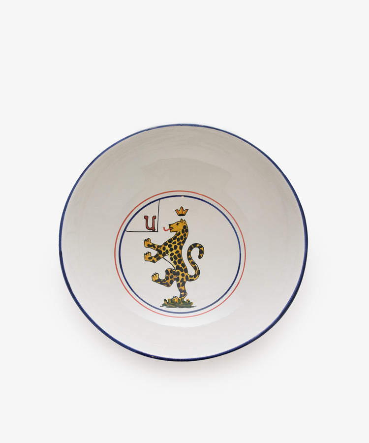 Palio Serving Bowl. Large white glazed ceramic bowl with red and blue accents and panther motif.