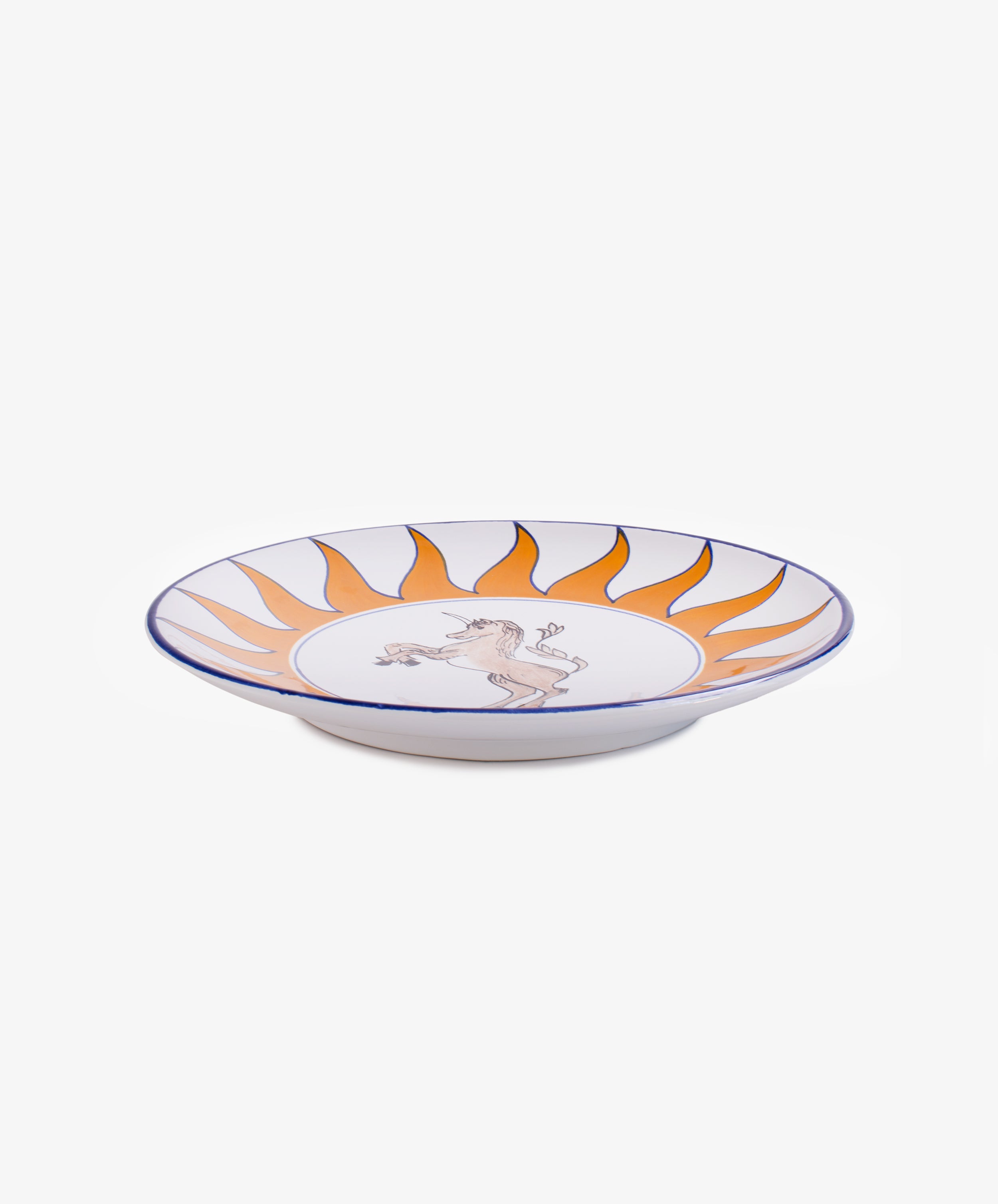 Palio Round Serving Platter. Large white glazed ceramic plate with orange and blue accents, side view.