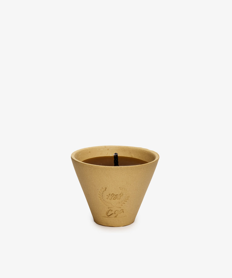 Enjoy summer evenings with the Francine Citronella Outdoor Candle—a tan, cone-shaped candle in a textured container with decorative embossing and a single black wick.