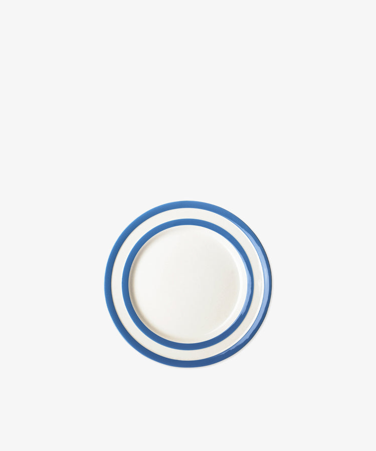 The Betty Breakfast Plate is a round white plate with two blue concentric rings near the rim, inspired by UK West Country pottery, shown on a plain white background.