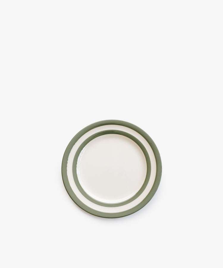 The Betty Breakfast Plate is a small white ceramic plate with two green circular stripes near the edge, inspired by classic UK West Country pottery, shown on a plain white background.