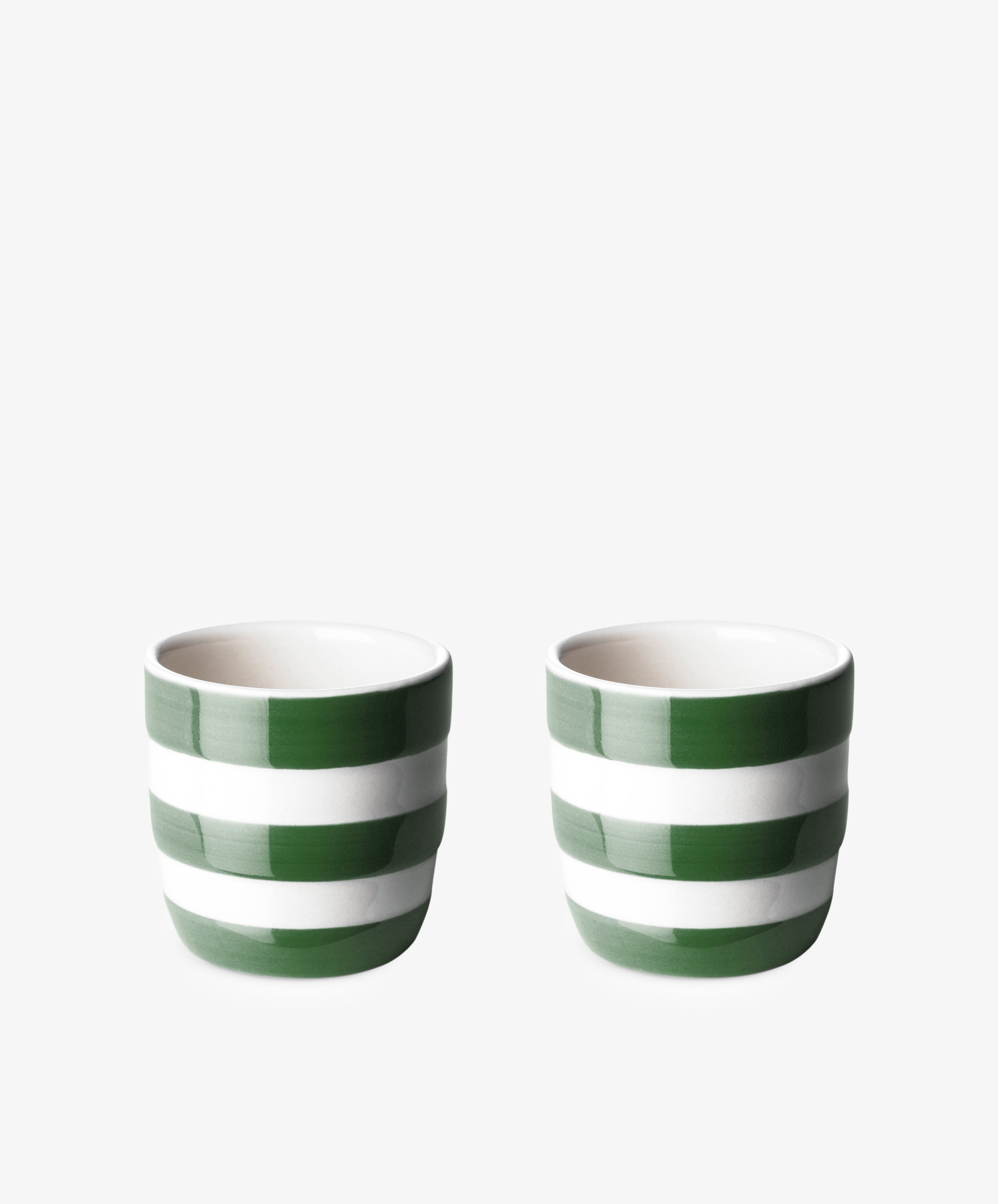 The Betty Egg cup, Set of 2, features small ceramic cups with green and white horizontal stripes, arranged side by side on a plain white background.