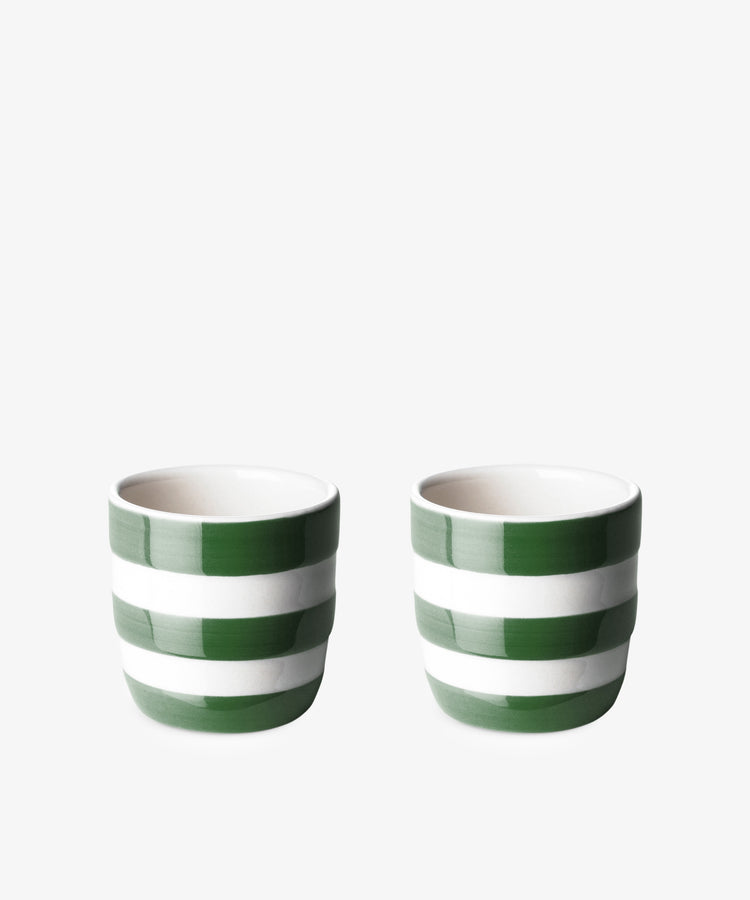 The Betty Egg cup, Set of 2, features small ceramic cups with green and white horizontal stripes, arranged side by side on a plain white background.
