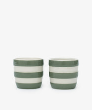 The Betty Egg Cup Set of 2 features ceramic cups with green and white horizontal stripes, inspired by UK West Country pottery, perfect for adding charm to your breakfast table.