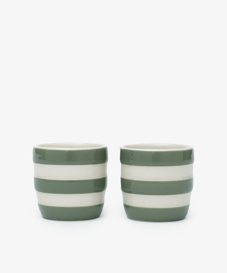 The Betty Egg Cup Set of 2 features ceramic cups with green and white horizontal stripes, inspired by UK West Country pottery, perfect for adding charm to your breakfast table.