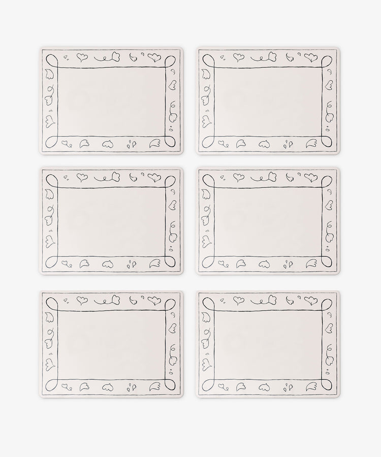 Set of 6 Capriccio Placemats with decorative black loop and leaf borders, arranged in two rows of three on a white background—ideal for stylish table décor from PORTA home.