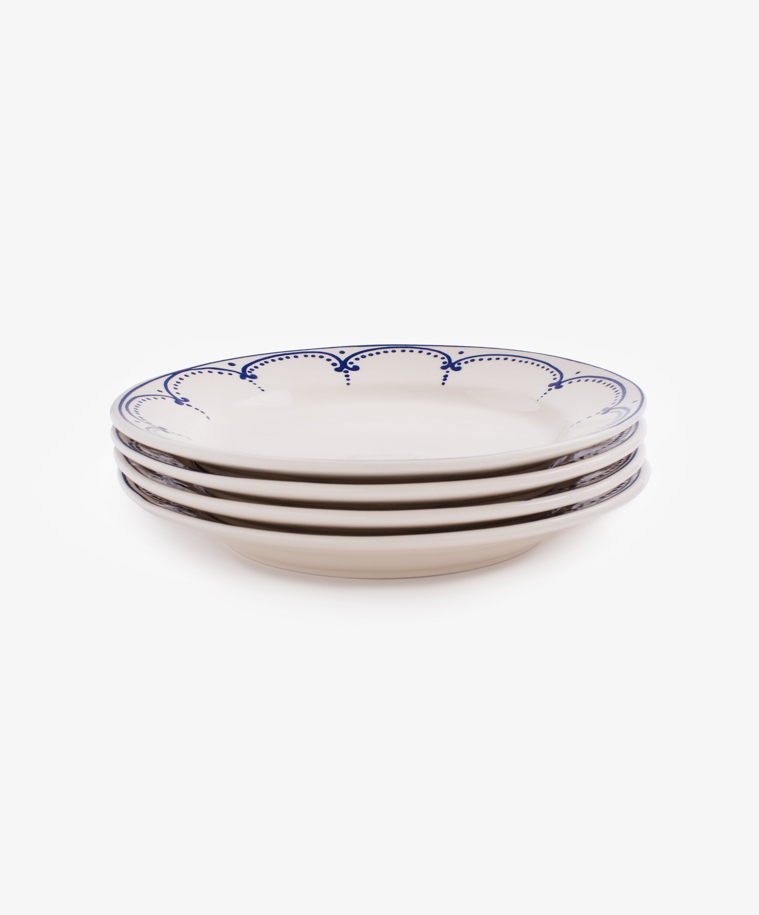 Stack of four white glazed ceramic Arco dinner plates.