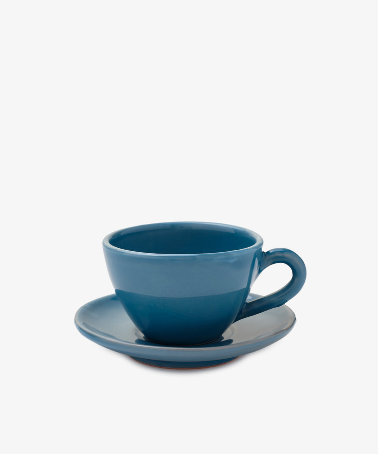 The Guido Coffee Set features a blue ceramic breakfast cup on a matching saucer, perfect for enjoying your morning coffee against a plain white background.