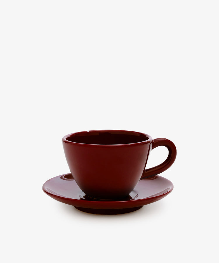 The Guido Coffee Set features a dark red ceramic breakfast cup with a matching saucer, displayed against a plain white background.