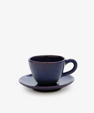 The Guido Coffee Set features a dark blue ceramic breakfast cup placed on a matching saucer, set against a plain white background.