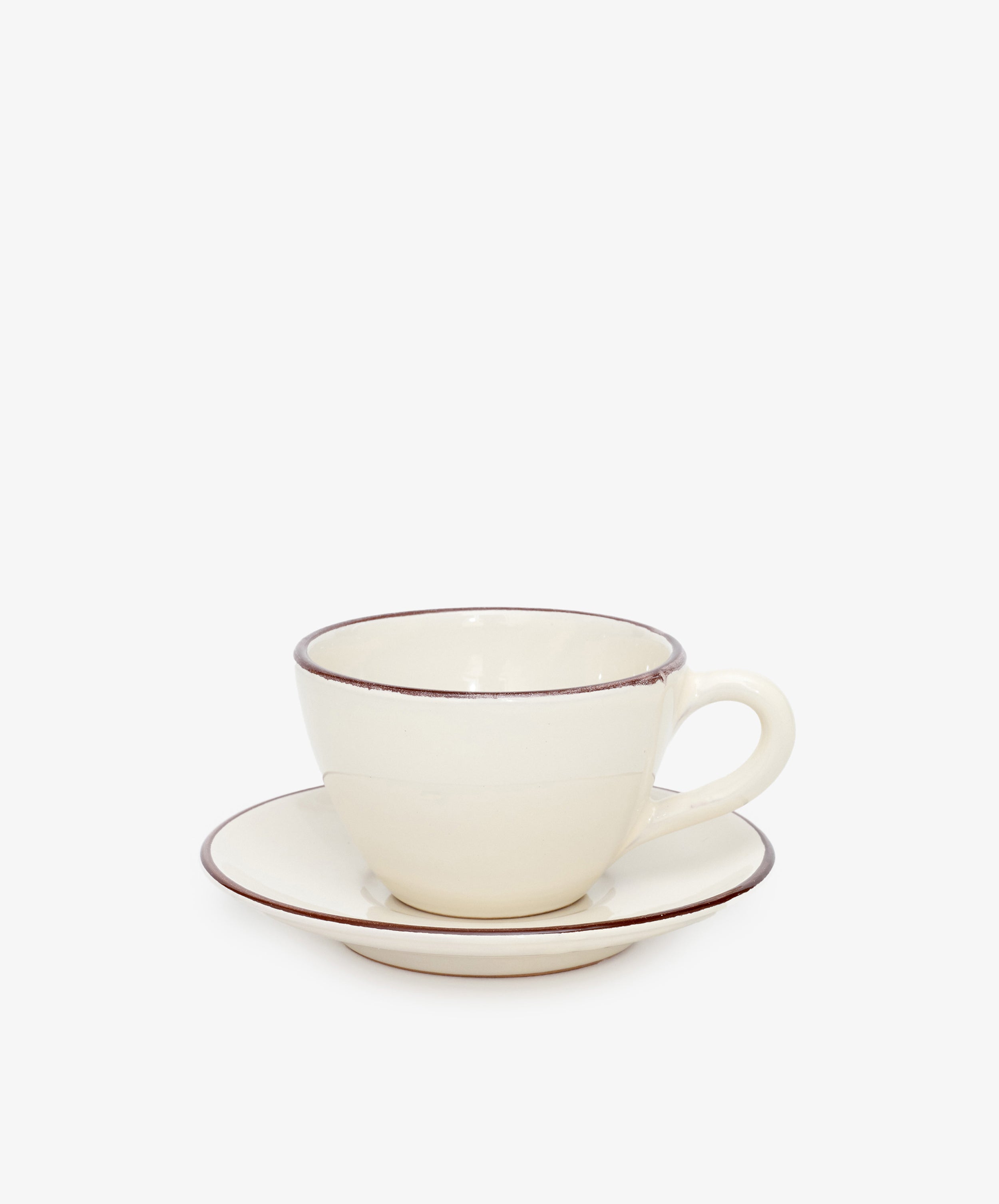 The Guido Coffee Set features a cream-colored ceramic breakfast cup with handle and a matching saucer, both accented by a thin brown rim, displayed against a plain white background.