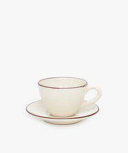 The Guido Coffee Set features a cream-colored ceramic breakfast cup with handle and a matching saucer, both accented by a thin brown rim, displayed against a plain white background.