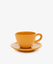 The Guido Coffee Set features a plain orange ceramic breakfast cup with a matching saucer, photographed on a white background—ideal for your morning coffee.
