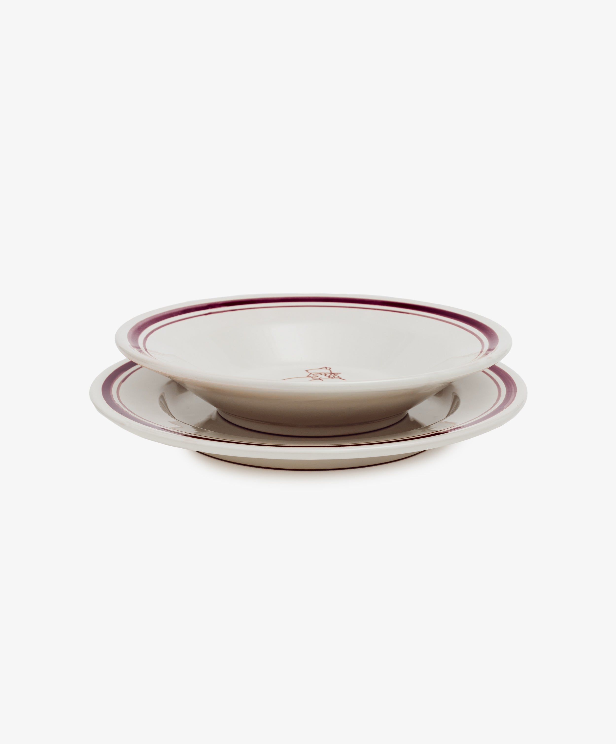 Two Folk Dinner Plates, Farmer—white ceramic with red rims and a small central decorative design, hand-painted by an Italian ceramist—are stacked together against a plain white background.