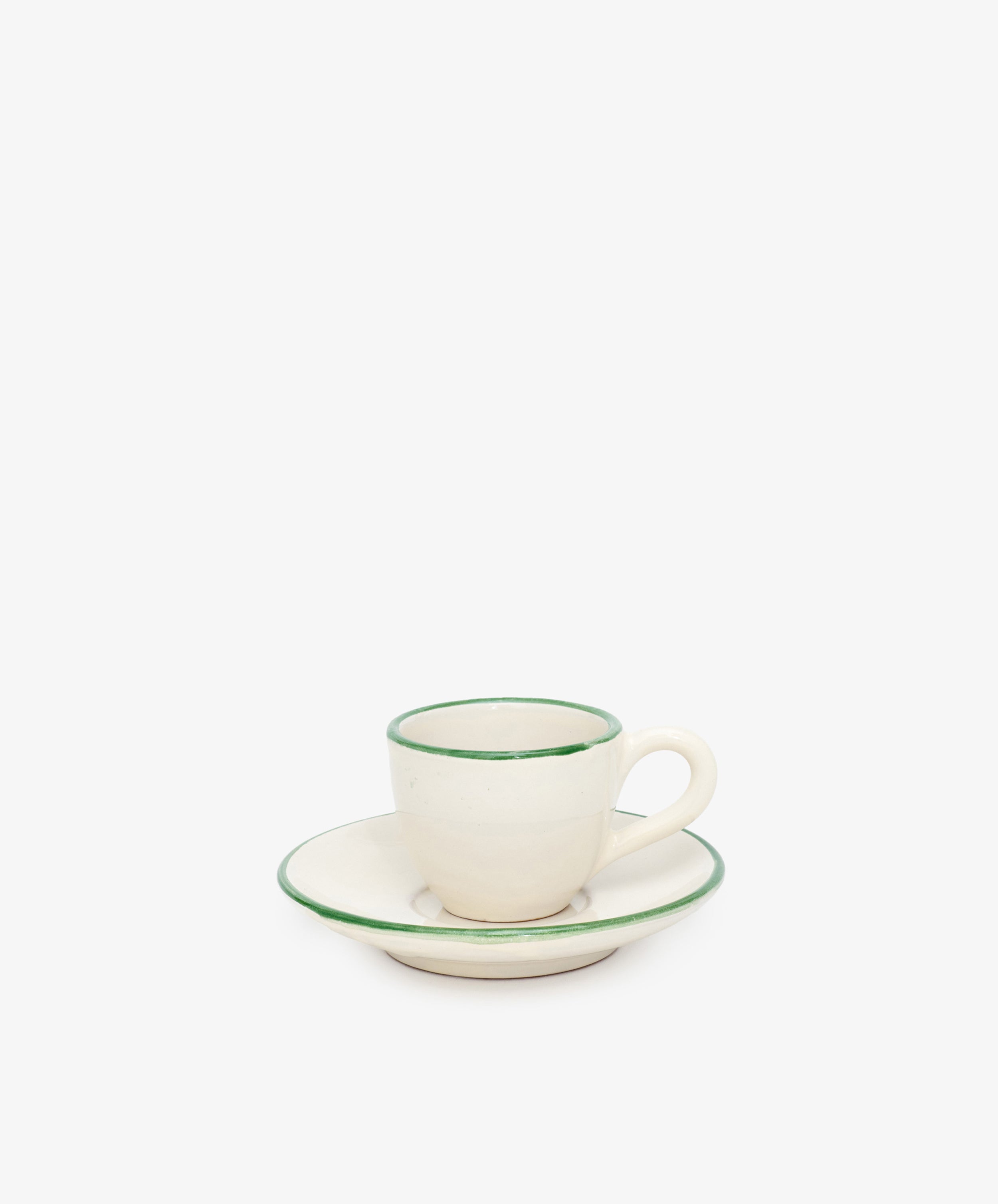 The Gio Espresso Set features a white ceramic espresso cup with a handle on a matching saucer, both accented with a thin green rim, shown against a plain white background.