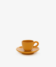 The Gio Espresso Set features a chic orange handmade ceramic espresso mug with handle, paired with a matching saucer, set against a plain white background.