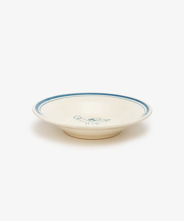 The Folk Pasta Bowl, Jester is a cream-colored ceramic bowl with a blue rim and a blue floral center design, hand-glazed by an Italian ceramist and photographed on a white background—a timeless tableware piece.