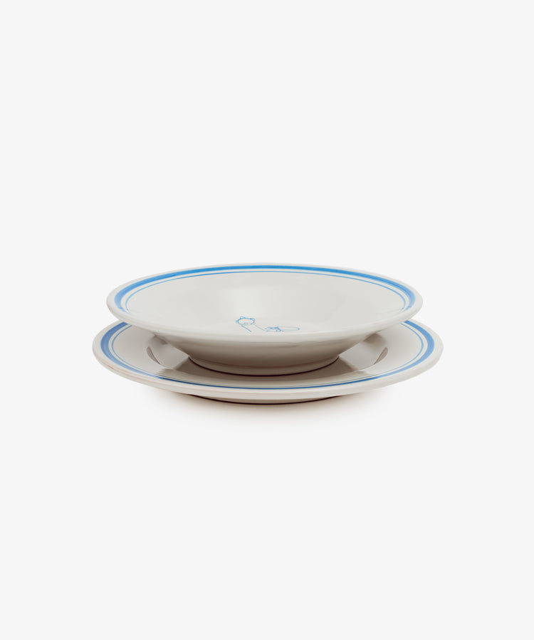 Two stacked Folk Pasta Bowls, Jester—white ceramic with blue rims and a central blue design—hand-glazed for a unique finish, shown against a white background.