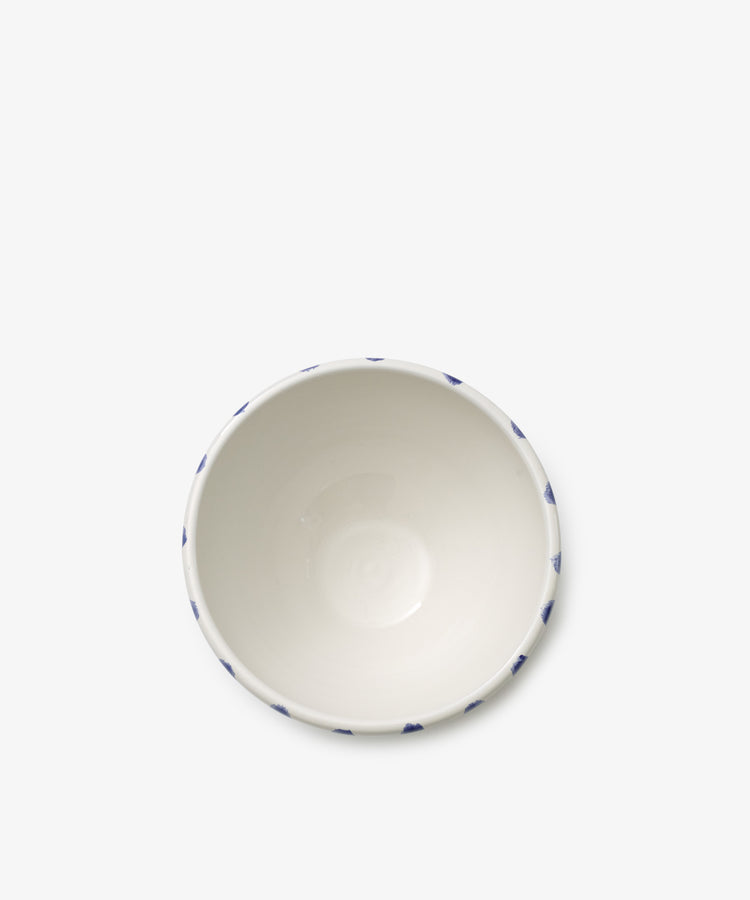 A set of four white ceramic Nina Bowls featuring a subtle blue triangular rim pattern, shown from above on a plain white background. Complements the matching small plate and platter for a coordinated table setting.