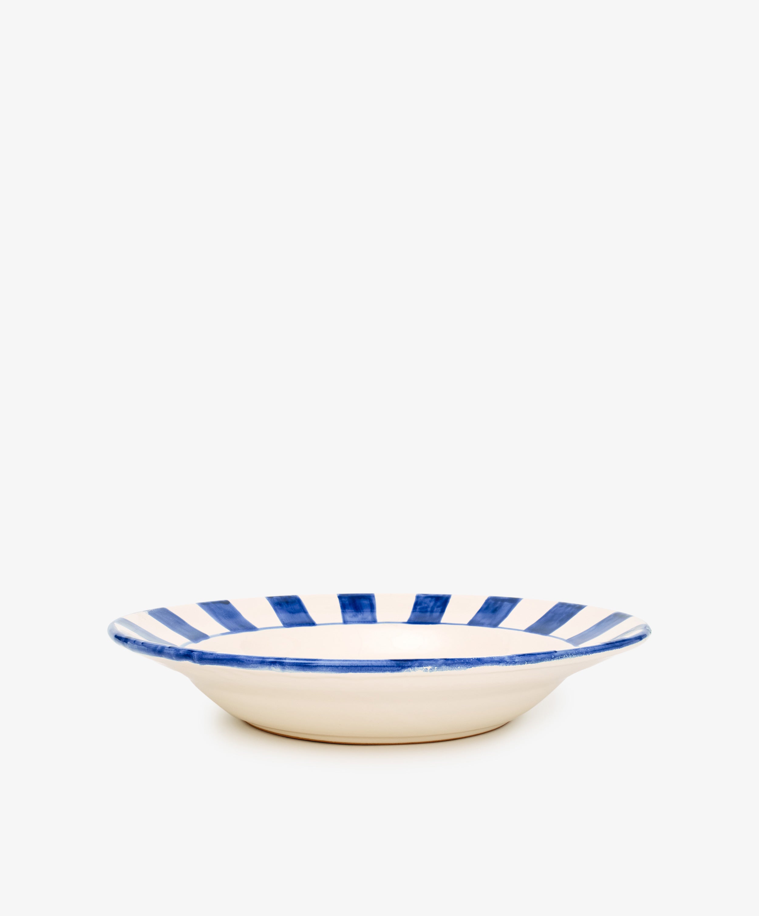 The Julius Serving Platter is a shallow ceramic plate with a cream base and bold stripes along the rim, shown against a plain white background.