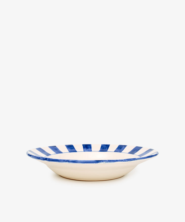 The Julius Serving Platter is a shallow ceramic plate with a cream base and bold stripes along the rim, shown against a plain white background.