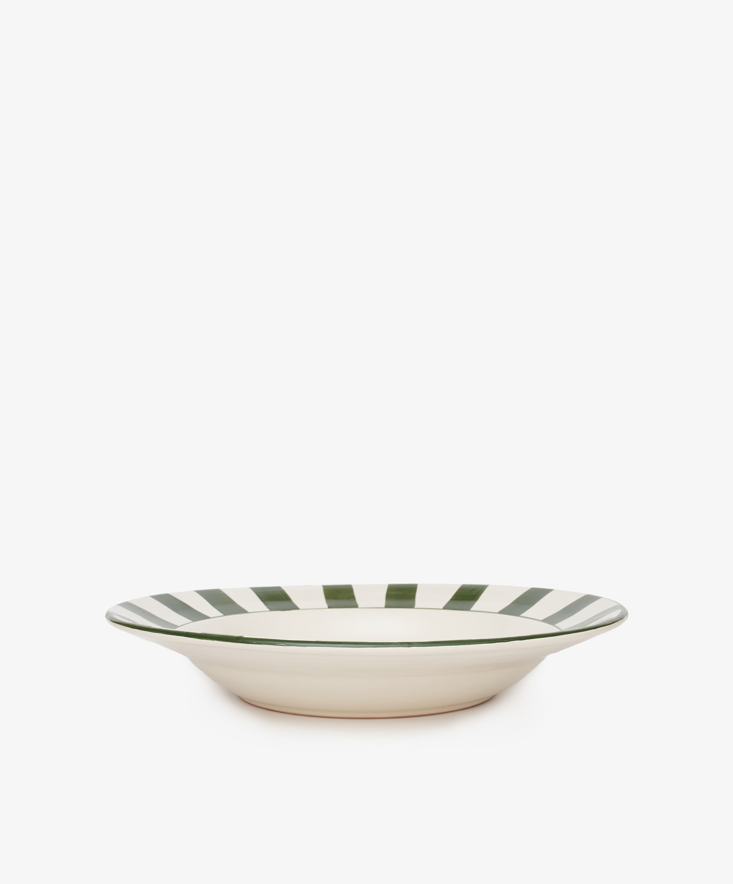 The Julius Serving Platter is a shallow, cream-colored ceramic bowl with bold green vertical stripes around the rim, photographed on a white background—perfect for adding easy sophistication to any table.