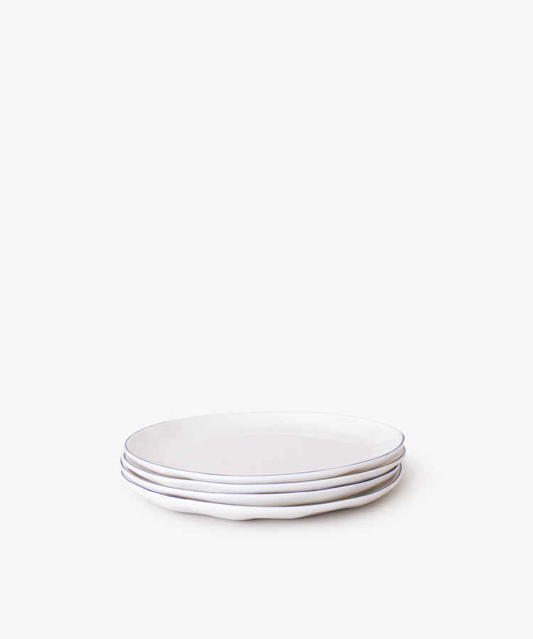 A set of four stacked white ceramic cake plates with gently wavy edges, shown on a plain white background—ideal for serving tea or desserts with the Cake Plate, Set of 4.