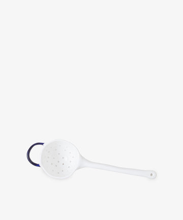 The Tea Strainer is a white plastic strainer with a long handle and small looped grip, perfect for loose leaf tea. Photographed on a plain white background.