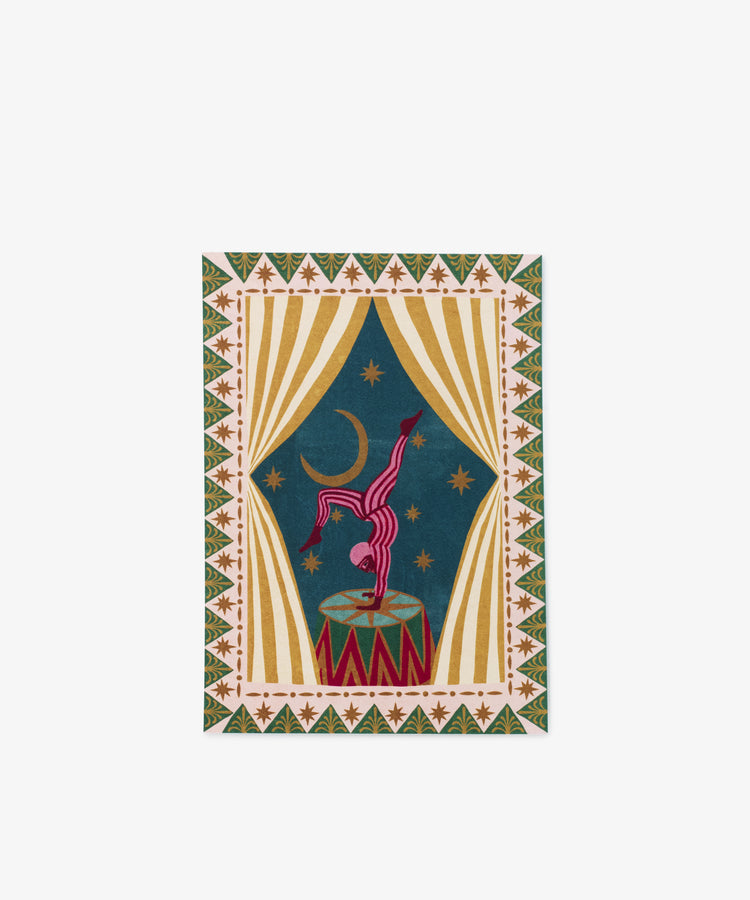 The PORTA Post is a colorful rectangular rug displaying a circus scene with a performer balancing on a drum, star patterns, curtains, handwritten words, and a crescent moon set against a blue background.