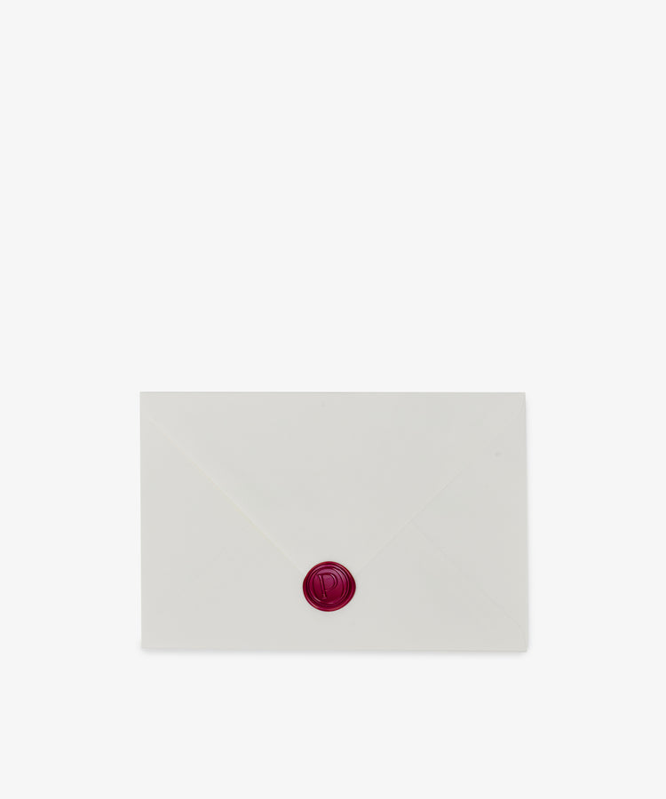 A PORTA Post card sits centered on a plain white background, enclosed in a closed white envelope sealed with red wax.