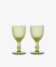 A set of six Celeste White Wine Glasses with diamond-cut surfaces and short stems, arranged side by side on a plain white background.