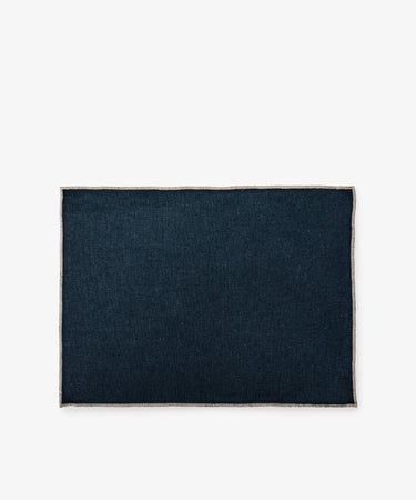 The Corte Placemat, Set of 6, features rectangular dark blue linen mats with light-colored edges, shown on a plain white background.