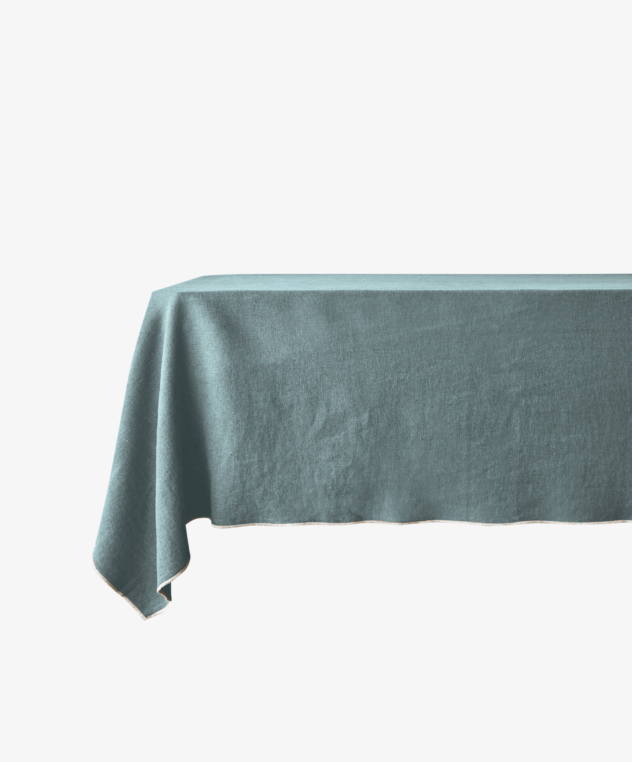 A rectangular table draped with the plain, light blue Corte Tablecloth brings sophistication to a white backdrop.