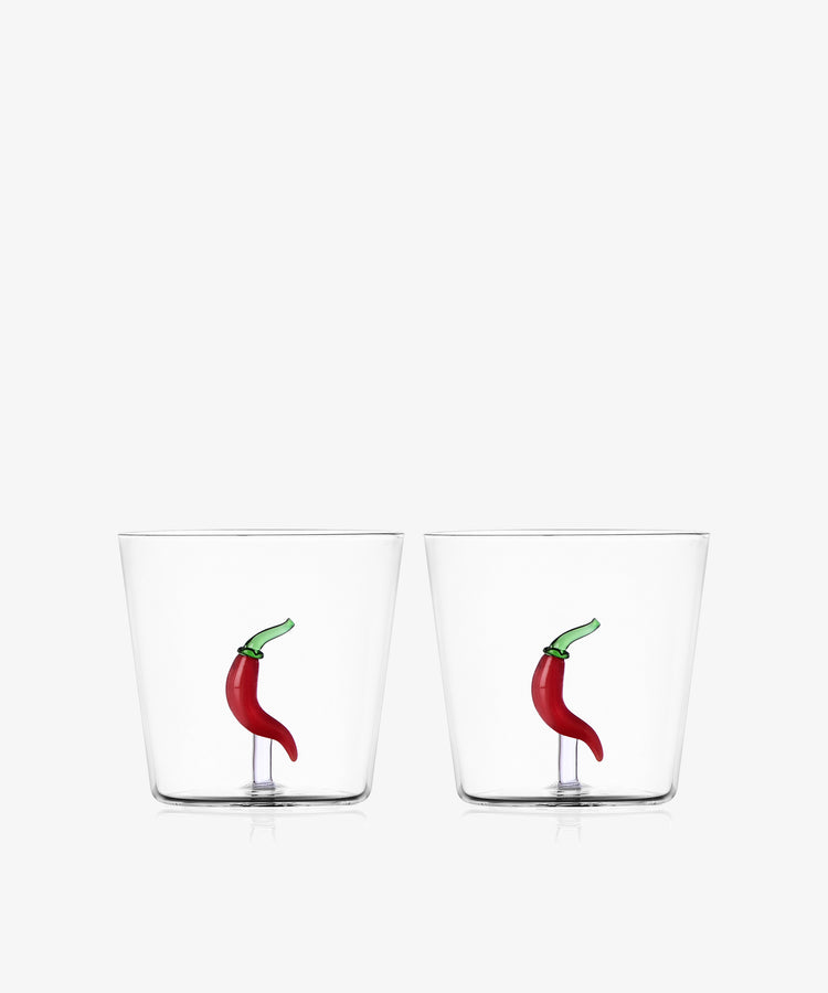 The Chili Pepper Tumbler, Set of 2, includes clear handcrafted borosilicate glass tumblers with a small red chili pepper design embedded at the bottom.