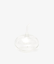 The Cylinder Oil & Vinegar Cruet features clear glass with a rounded base and curved spout, reminiscent of elegant cruets, displayed against a plain white background.