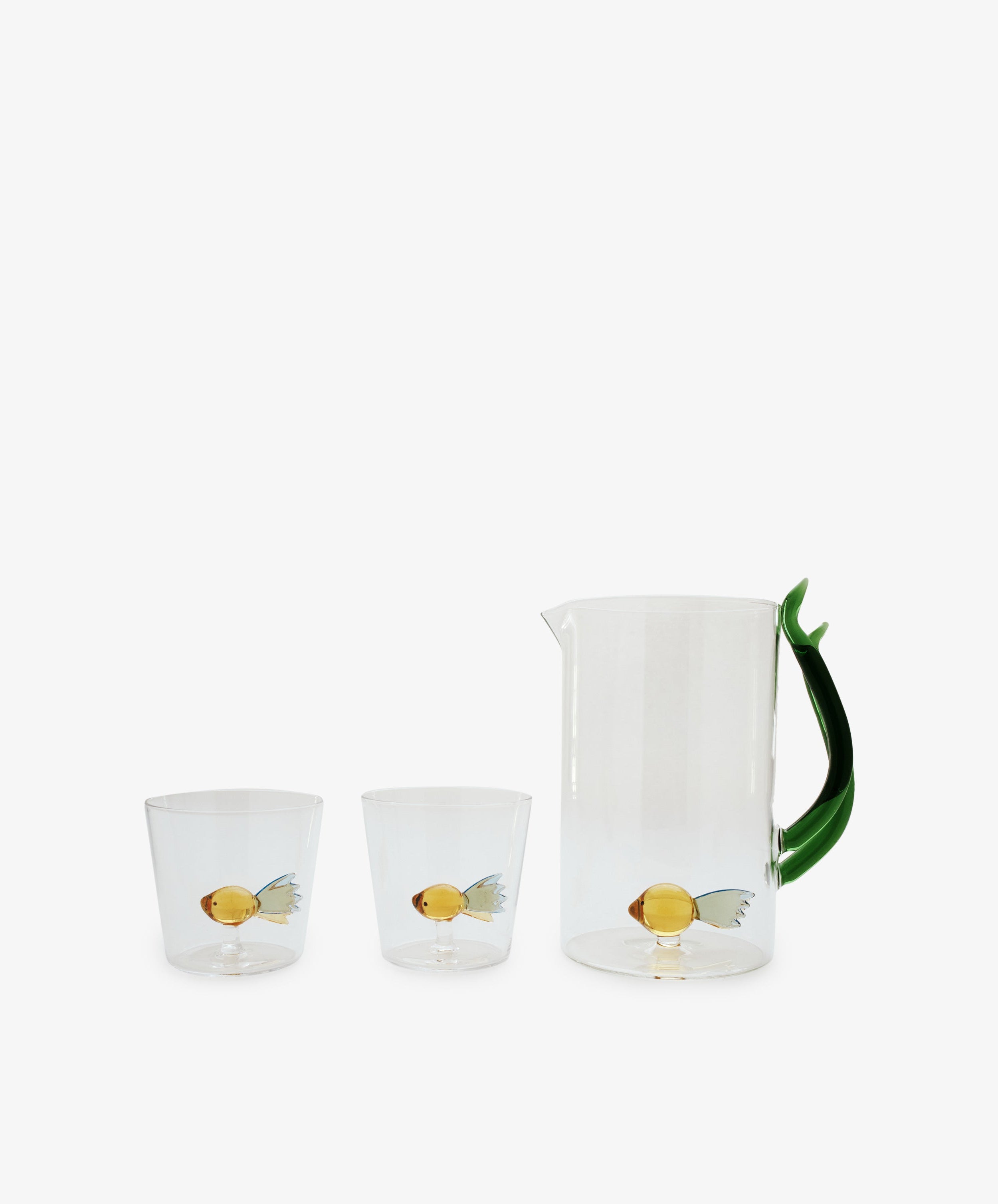 A set of two Fish Tumblers by Ichendorf Milano, crafted from clear borosilicate glass, each adorned with a yellow fish with blue fins—a display of classic craftsmanship.